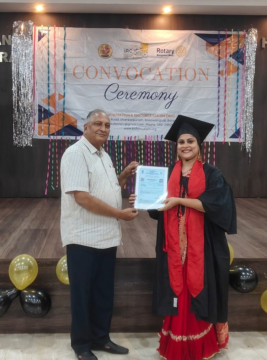 Farzana, founder of 5 Pillars, receiving a certificate of recognition on stage